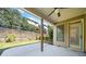 Outdoor patio with a ceiling fan and views of the backyard and landscaping at 8360 Village School Dr, Cumming, GA 30041