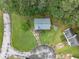 Aerial view of a well manicured property with a large yard, mature trees, and a paved driveway at 2485 Shady Shoals Ct, Decatur, GA 30034