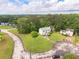 An aerial view of a house with a lush green lawn, driveway and tree lined street at 2485 Shady Shoals Ct, Decatur, GA 30034