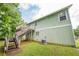 Exterior rear view of light green house with wooden deck, staircase and grassy yard at 2485 Shady Shoals Ct, Decatur, GA 30034