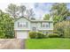 Charming two-story home with green siding, shutters, brick accents, garage and a well-maintained front yard at 2485 Shady Shoals Ct, Decatur, GA 30034