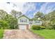 Charming two-story home with green siding, shutters, brick accents, garage and a well-maintained front yard at 2485 Shady Shoals Ct, Decatur, GA 30034