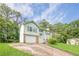 Charming two-story home with green siding, shutters, brick accents, garage and a well-maintained front yard at 2485 Shady Shoals Ct, Decatur, GA 30034