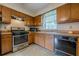 Functional kitchen design features wood cabinetry, laminate countertop and stainless steel oven at 2485 Shady Shoals Ct, Decatur, GA 30034