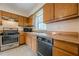 Functional kitchen design features wood cabinetry, laminate countertop and stainless steel oven at 2485 Shady Shoals Ct, Decatur, GA 30034