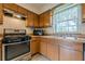 Functional kitchen design features wood cabinetry, laminate countertop and stainless steel oven at 2485 Shady Shoals Ct, Decatur, GA 30034
