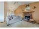 Cozy living room features a brick fireplace, neutral carpeting and a lighted ceiling fan at 2485 Shady Shoals Ct, Decatur, GA 30034