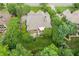 Aerial view of home and backyard surrounded by lush landscaping and mature trees at 2840 Astoria Ave, Cumming, GA 30040