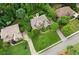 An aerial view of a charming home with brick and stone accents, lush landscaping, and well-manicured lawn at 2840 Astoria Ave, Cumming, GA 30040