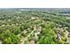 Aerial view of community and home surrounded by lush trees with a small pond nearby at 2840 Astoria Ave, Cumming, GA 30040
