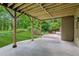 A covered back patio is perfect for outdoor dining, with a lush backyard and green lawn at 2840 Astoria Ave, Cumming, GA 30040