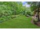 A lush green lawn and manicured garden beds define the home's expansive backyard at 2840 Astoria Ave, Cumming, GA 30040