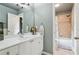 Bright bathroom featuring a vanity with storage, a large mirror, and a shower-tub combo at 2840 Astoria Ave, Cumming, GA 30040
