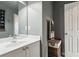 Neutral bathroom with a vanity, mirror, towel rack, and door, with light-colored wall and fixtures at 2840 Astoria Ave, Cumming, GA 30040