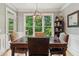 Bright dining room with a large window, stylish light fixture, and neutral wall colors at 2840 Astoria Ave, Cumming, GA 30040