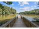 Scenic view of a wooden dock leading to a tranquil lake surrounded by lush greenery at 2840 Astoria Ave, Cumming, GA 30040
