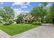 Charming home with brick and stone accents, lush landscaping and a long driveway to a side garage at 2840 Astoria Ave, Cumming, GA 30040