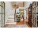 Bright foyer with hardwood floors, staircase, and a view into the living room at 2840 Astoria Ave, Cumming, GA 30040