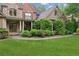 Charming home with brick and stone accents, lush landscaping, and a walkway to the front door at 2840 Astoria Ave, Cumming, GA 30040
