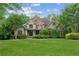 Charming two-story home with brick and stone accents, lush landscaping, and a well-manicured lawn at 2840 Astoria Ave, Cumming, GA 30040
