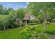 Charming home with brick and stone accents, lush landscaping, and a walkway to the front door at 2840 Astoria Ave, Cumming, GA 30040