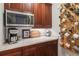 Kitchenette featuring granite countertops, modern appliances, custom mug rack and dark wood cabinets at 2840 Astoria Ave, Cumming, GA 30040
