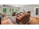 Spacious living room with hardwood floors, ample seating and abundant natural light, with views to the exterior at 2840 Astoria Ave, Cumming, GA 30040
