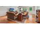 Bright and airy living room showcasing hardwood floors and well-appointed furniture, with views of the backyard at 2840 Astoria Ave, Cumming, GA 30040