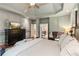 Elegant main bedroom with tray ceilings, hardwood floors, and a large window at 2840 Astoria Ave, Cumming, GA 30040