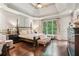 Elegant main bedroom with tray ceilings, hardwood floors, and a large window at 2840 Astoria Ave, Cumming, GA 30040
