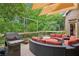 Relaxing outdoor deck featuring a large seating area, grill, and a beautiful wooded backdrop at 2840 Astoria Ave, Cumming, GA 30040