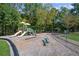 Community playground with slides, swings, and play structures in a wooded area at 2840 Astoria Ave, Cumming, GA 30040