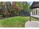 Spacious backyard features lush greenery, a trampoline, and covered patio area perfect for outdoor enjoyment at 1042 Trailridge Pl, Atlanta, GA 30338