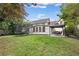 Expansive backyard view showcasing a trampoline, patio, and well-maintained green lawn at 1042 Trailridge Pl, Atlanta, GA 30338