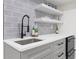 Modern bar area with white countertops, gray cabinets, and floating shelves at 1042 Trailridge Pl, Atlanta, GA 30338