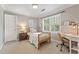 Calm bedroom featuring a twin bed, white shutters, and a work desk at 1042 Trailridge Pl, Atlanta, GA 30338