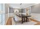 Formal dining room with modern chandelier, neutral paint and wainscoting at 1042 Trailridge Pl, Atlanta, GA 30338
