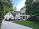 Charming two-story home featuring a balcony, brick accents, manicured lawn and a long driveway at 1042 Trailridge Pl, Atlanta, GA 30338