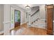 Elegant foyer with hardwood floors, staircase, and decorative accents creating a warm, inviting ambiance at 1042 Trailridge Pl, Atlanta, GA 30338