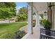 Relaxing front porch with ample seating, decorative shrubbery, and views of the manicured lawn at 1042 Trailridge Pl, Atlanta, GA 30338