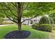 Spacious front yard with mature trees and professionally landscaped for exceptional curb appeal at 1042 Trailridge Pl, Atlanta, GA 30338