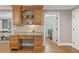 Kitchen desk area with wood cabinets, granite countertops and view of the laundry room at 1042 Trailridge Pl, Atlanta, GA 30338