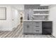 Modern kitchenette boasts gray cabinets, floating shelves, and a beverage cooler, perfect for entertaining at 1042 Trailridge Pl, Atlanta, GA 30338