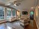 Bright living room featuring hardwood floors, large windows, and modern neutral-toned furniture at 1042 Trailridge Pl, Atlanta, GA 30338