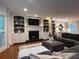 Cozy living room featuring a fireplace with white shelving and a comfortable, oversized sectional couch at 1042 Trailridge Pl, Atlanta, GA 30338