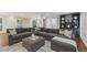 Spacious living room with an oversized sectional sofa, ottoman, and stylish decor at 1042 Trailridge Pl, Atlanta, GA 30338
