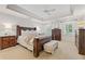 Main bedroom with tray ceilings, carpet floors, and ensuite bathroom at 1042 Trailridge Pl, Atlanta, GA 30338
