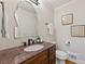 Modern powder room with dark cabinets, decorative mirror and neutral colors at 1042 Trailridge Pl, Atlanta, GA 30338