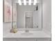 Bright bathroom featuring a white vanity with undermount sink, a large mirror and artist painting on wall at 6179 Ashbranch Dr, Acworth, GA 30101