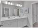 Bright bathroom features double vanity sinks, large mirror, and stylish lighting fixtures at 6179 Ashbranch Dr, Acworth, GA 30101